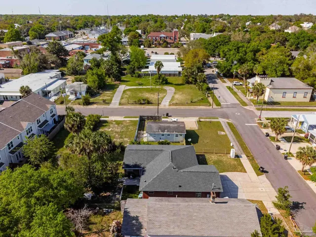 an aerial view of residential houses with outdoor space