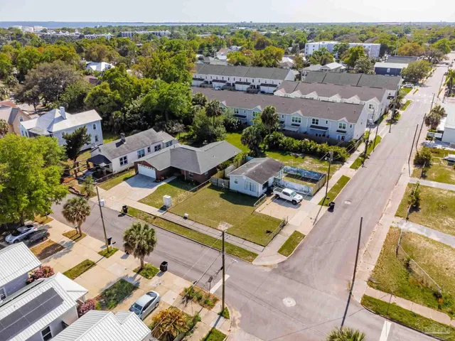 an aerial view of a house with a yard