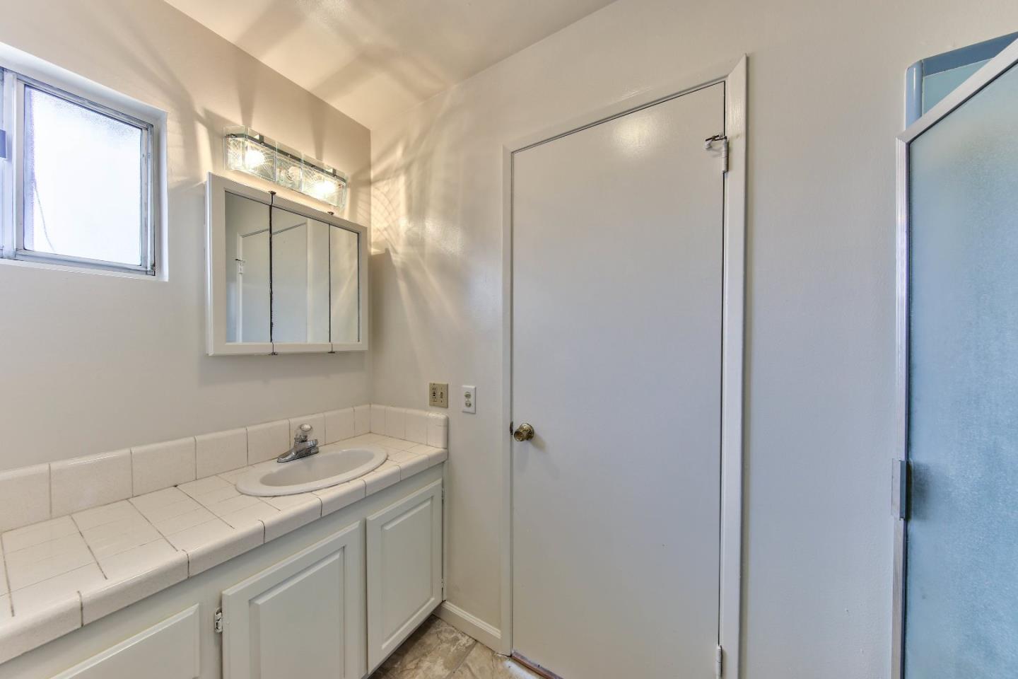 3283 Michael Drive Marina, CA 93933 - Photo 13 of 19 a bathroom with a granite countertop sink and a mirror