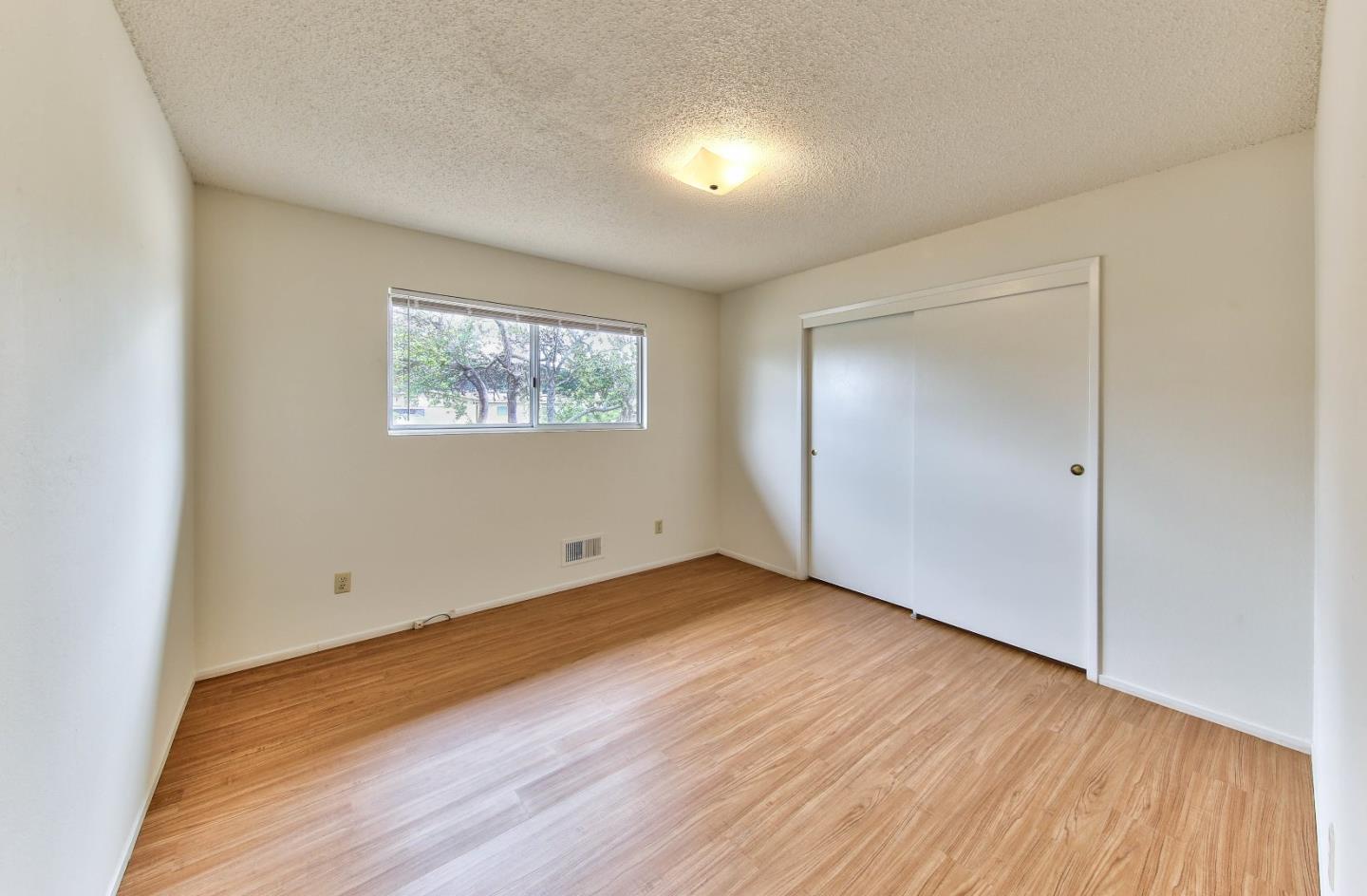 3283 Michael Drive Marina, CA 93933 - Photo 14 of 19 an empty room with wooden floor and windows