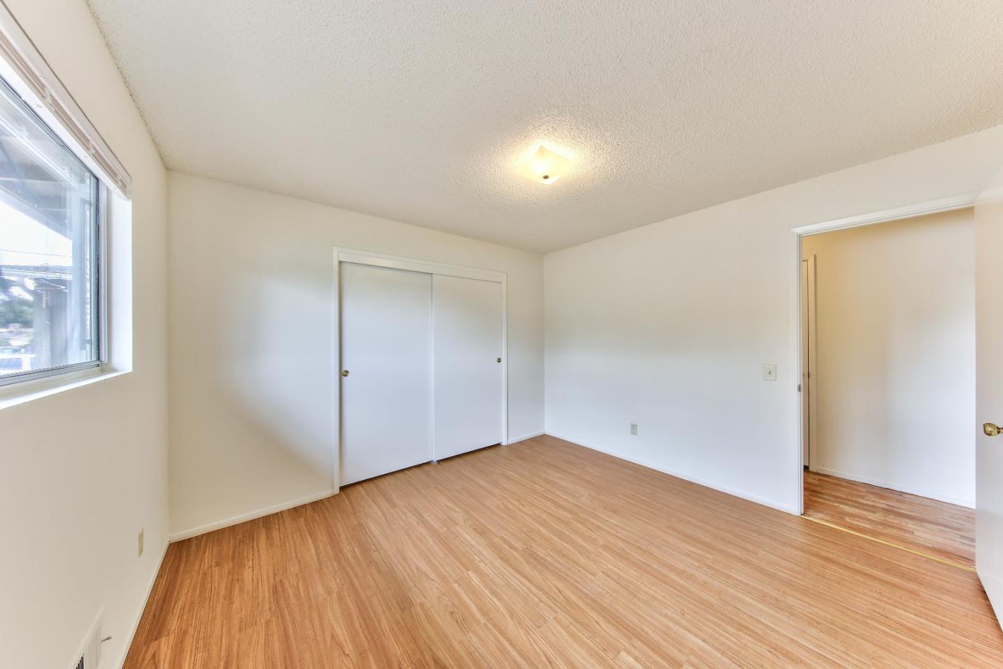 3283 Michael Drive Marina, CA 93933 - Photo 15 of 19 an empty room with wooden floor and windows