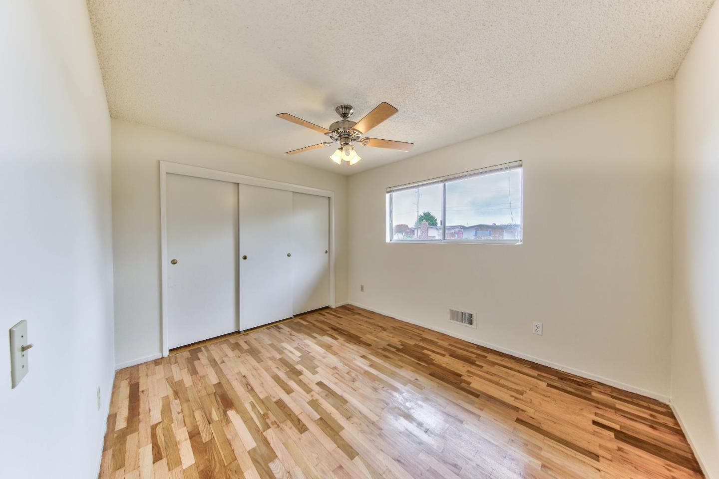3283 Michael Drive Marina, CA 93933 - Photo 17 of 19 a view of a big room with wooden floor and a ceiling fan