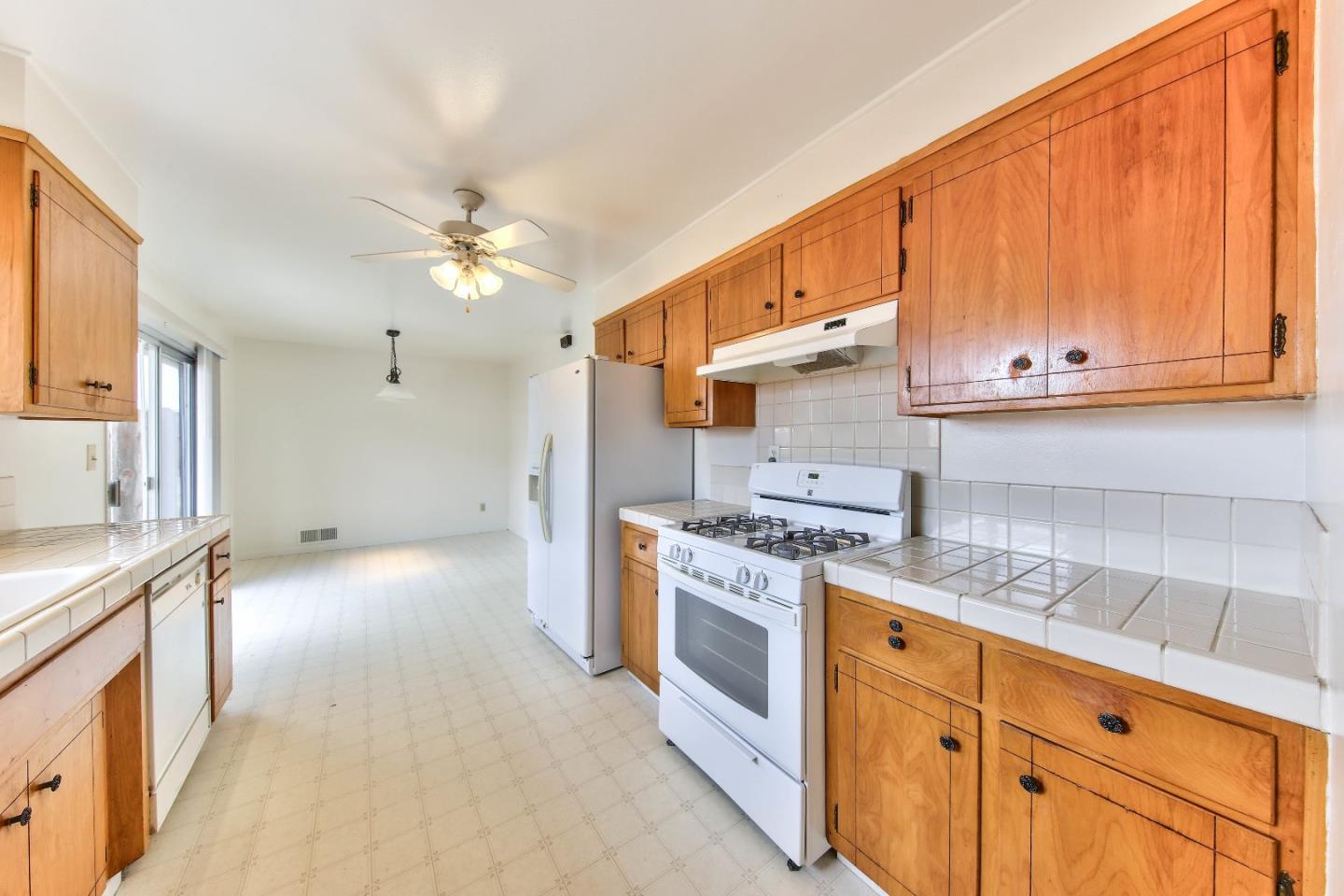 3283 Michael Drive Marina, CA 93933 - Photo 7 of 19 a kitchen with stainless steel appliances granite countertop a stove a sink and a refrigerator
