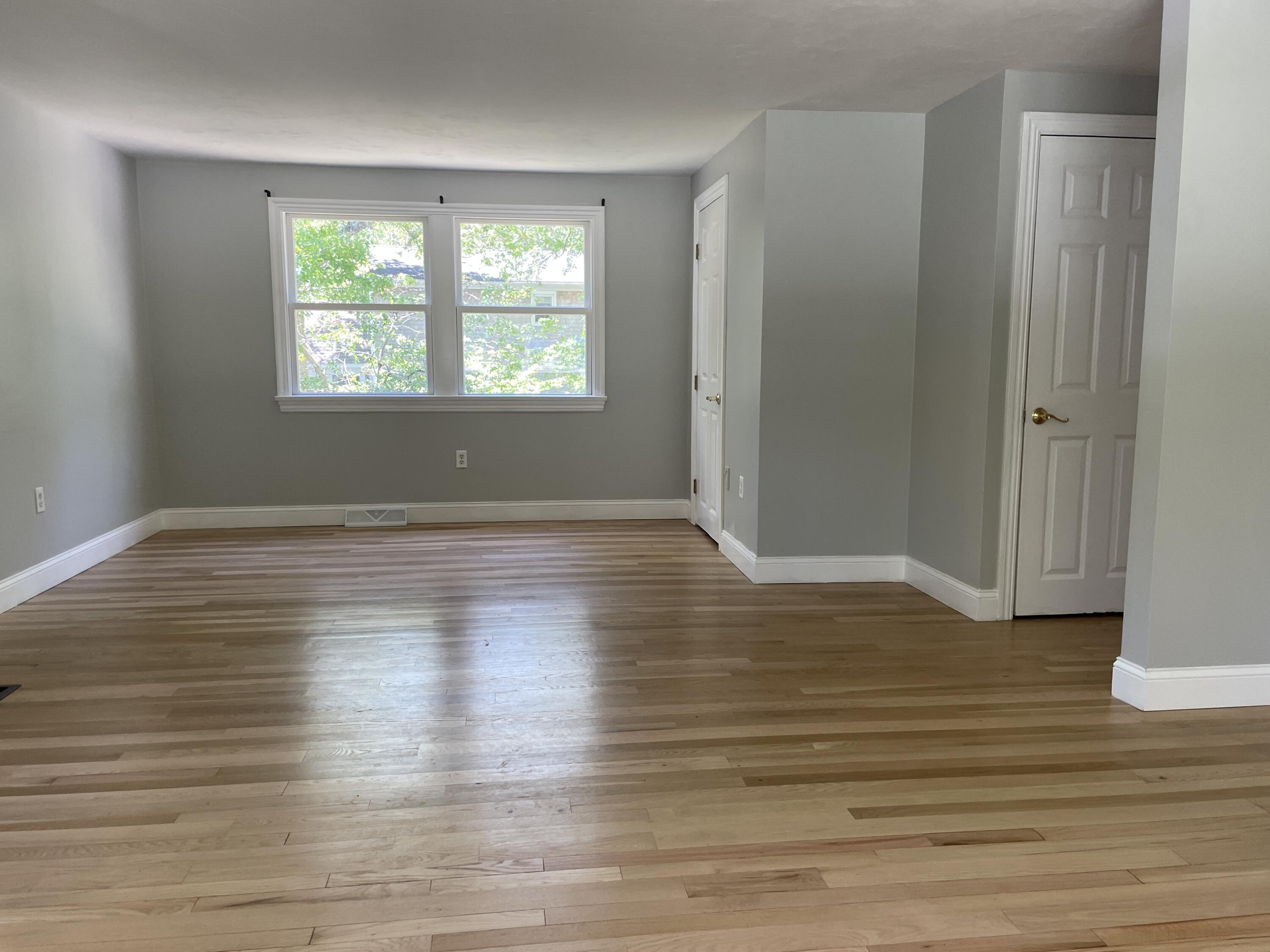 42 Forest Drive Mashpee, MA 02649 - Photo 11 of 55 an empty room with wooden floor and windows