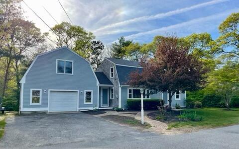 42 Forest Drive Mashpee, MA 02649 - Photo 13 of 55 a front view of a house with a garden