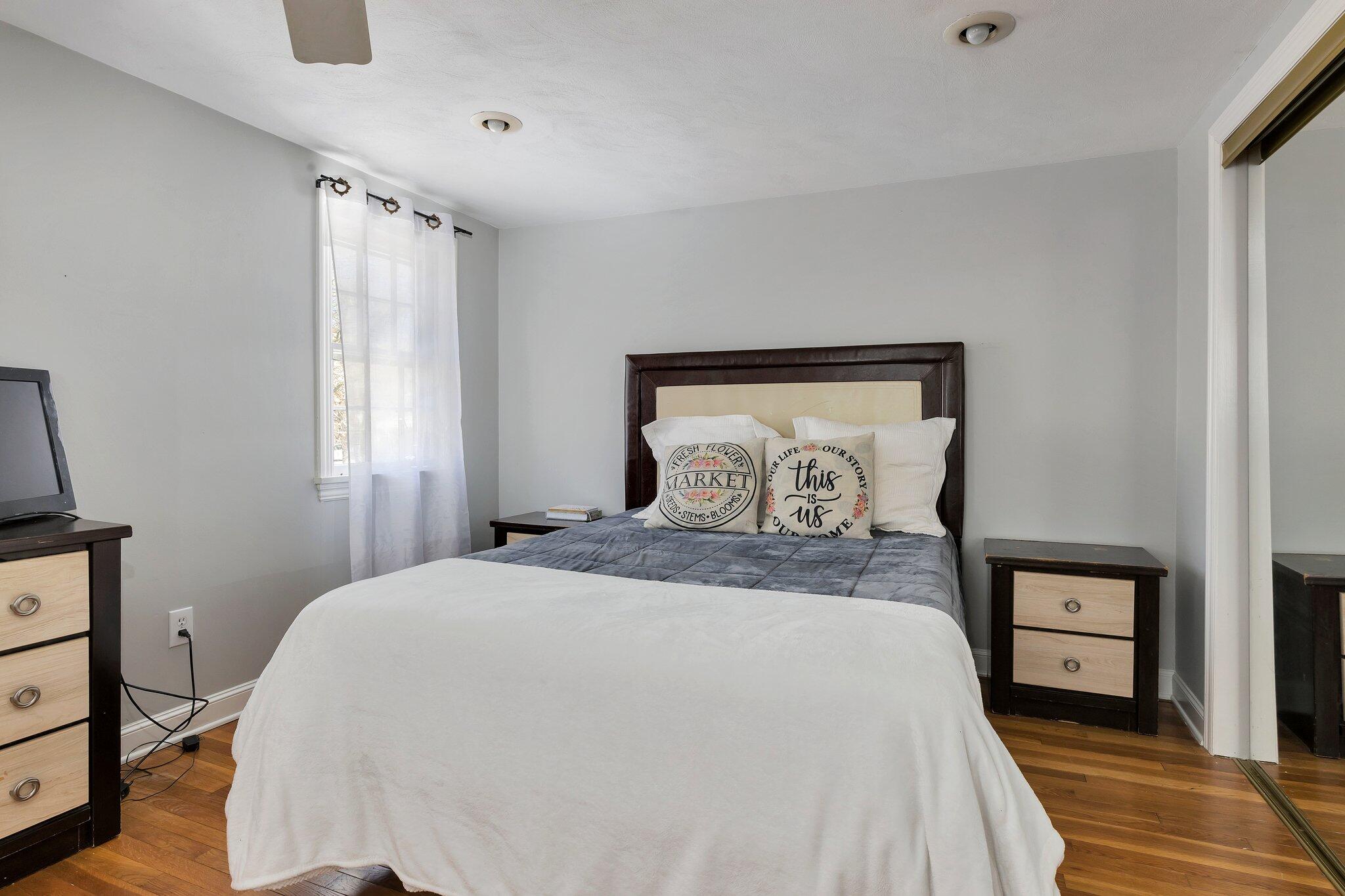 42 Forest Drive Mashpee, MA 02649 - Photo 16 of 55 a bedroom with a bed and wooden floor
