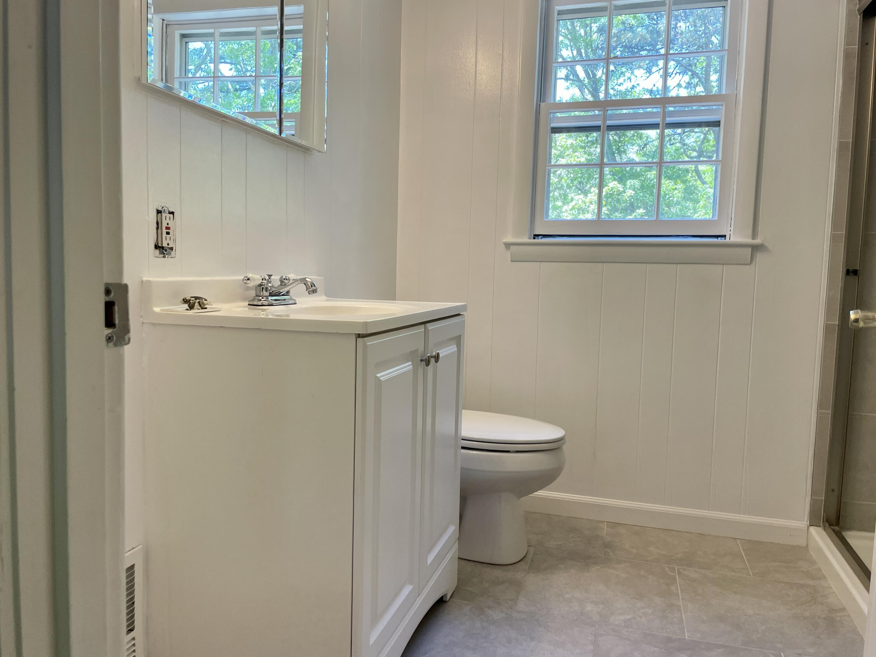 42 Forest Drive Mashpee, MA 02649 - Photo 21 of 55 a view of bathroom with a toilet sink and mirror