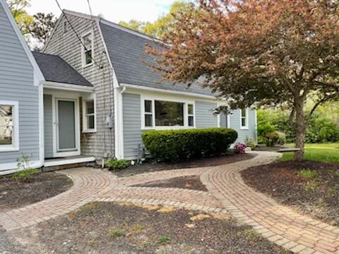 42 Forest Drive Mashpee, MA 02649 - Photo 35 of 55 a front view of a house with a yard and potted plants