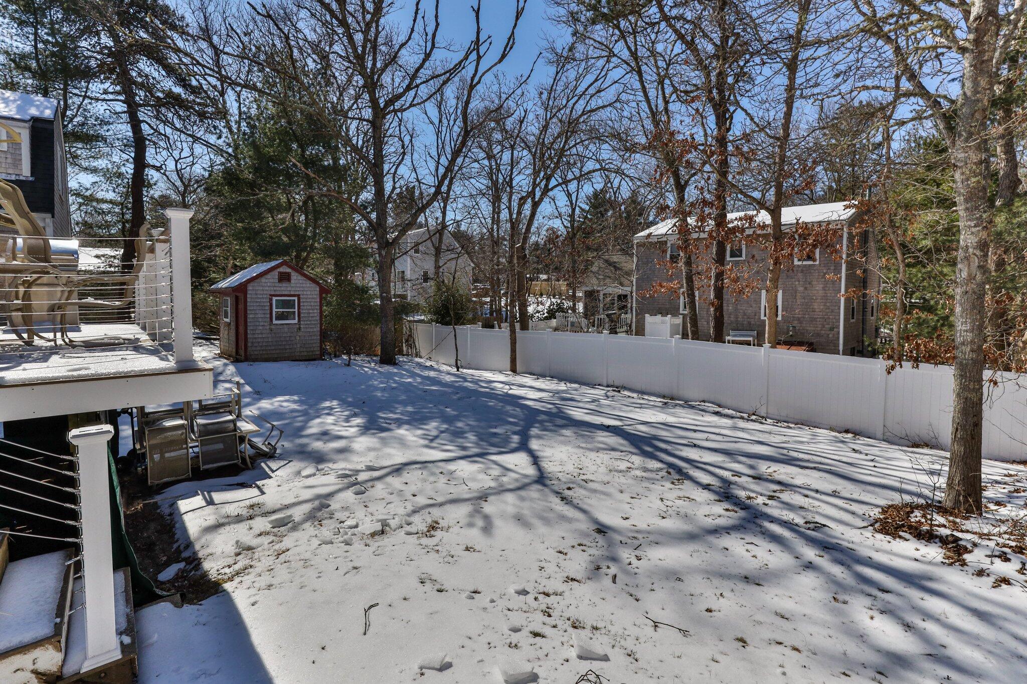 42 Forest Drive Mashpee, MA 02649 - Photo 41 of 55 a view of a backyard with snow on the house