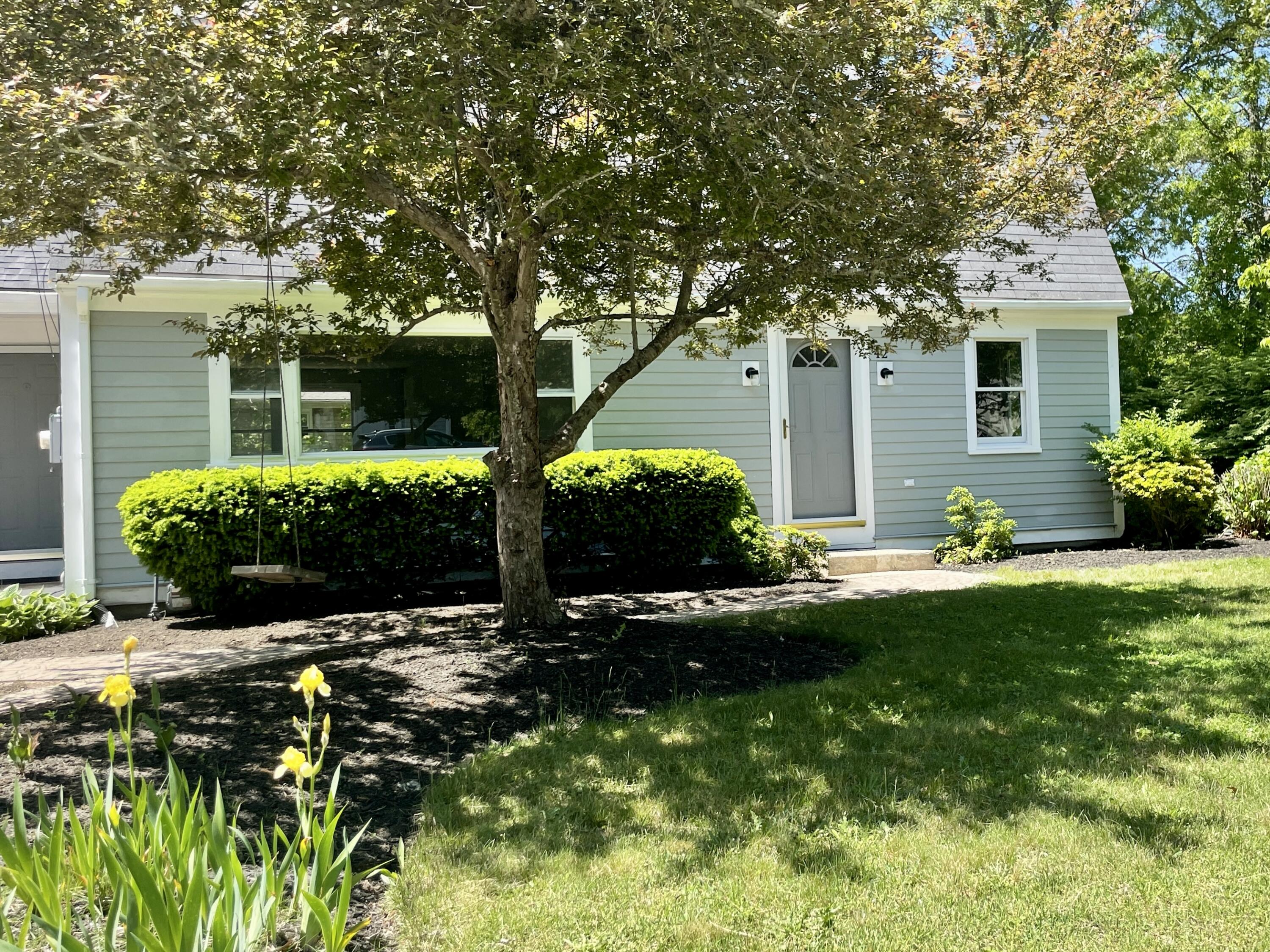 42 Forest Drive Mashpee, MA 02649 - Photo 53 of 55 a front view of a house with a yard and outdoor seating