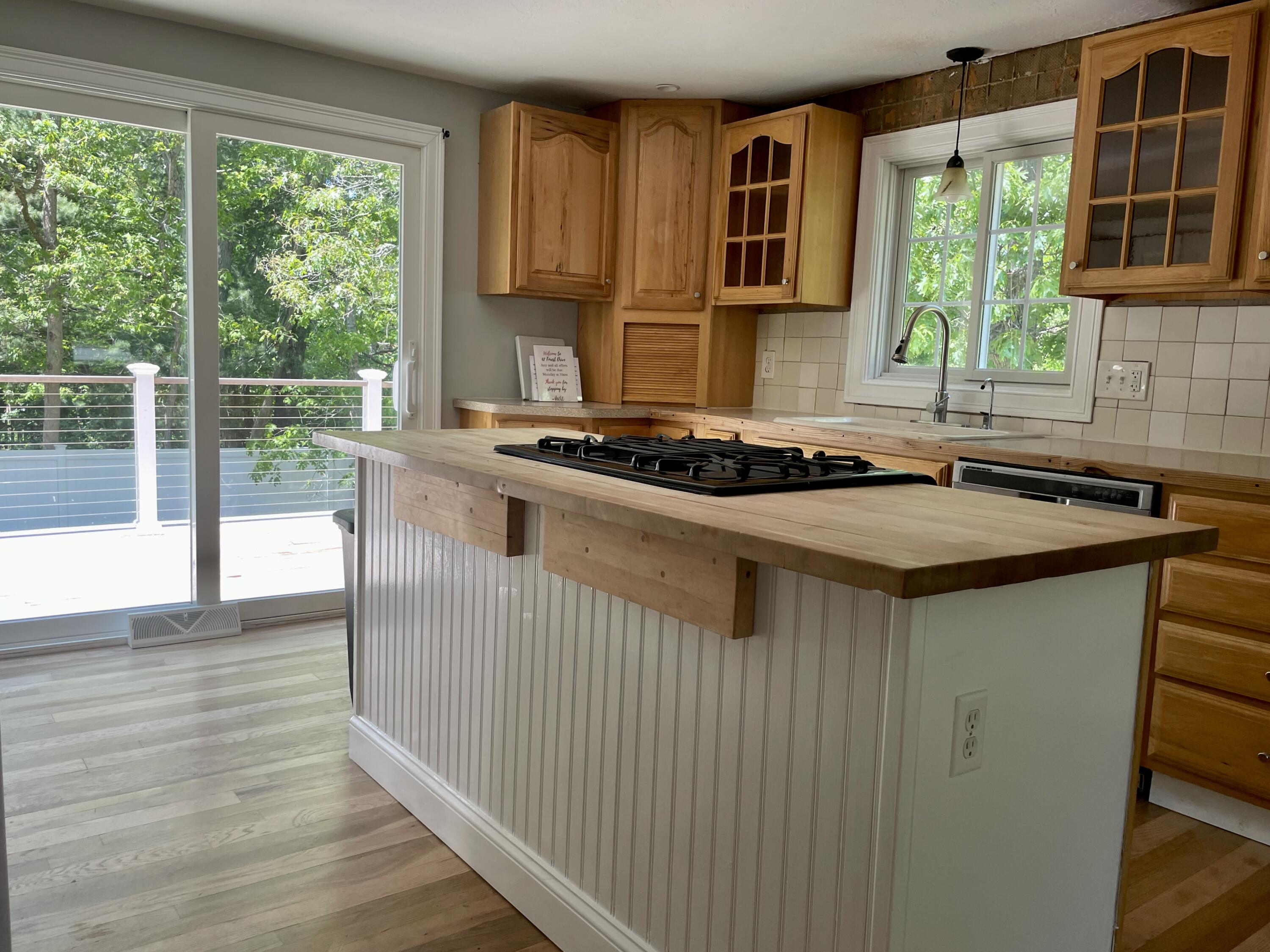 42 Forest Drive Mashpee, MA 02649 - Photo 5 of 55 a kitchen with a sink a window and cabinets