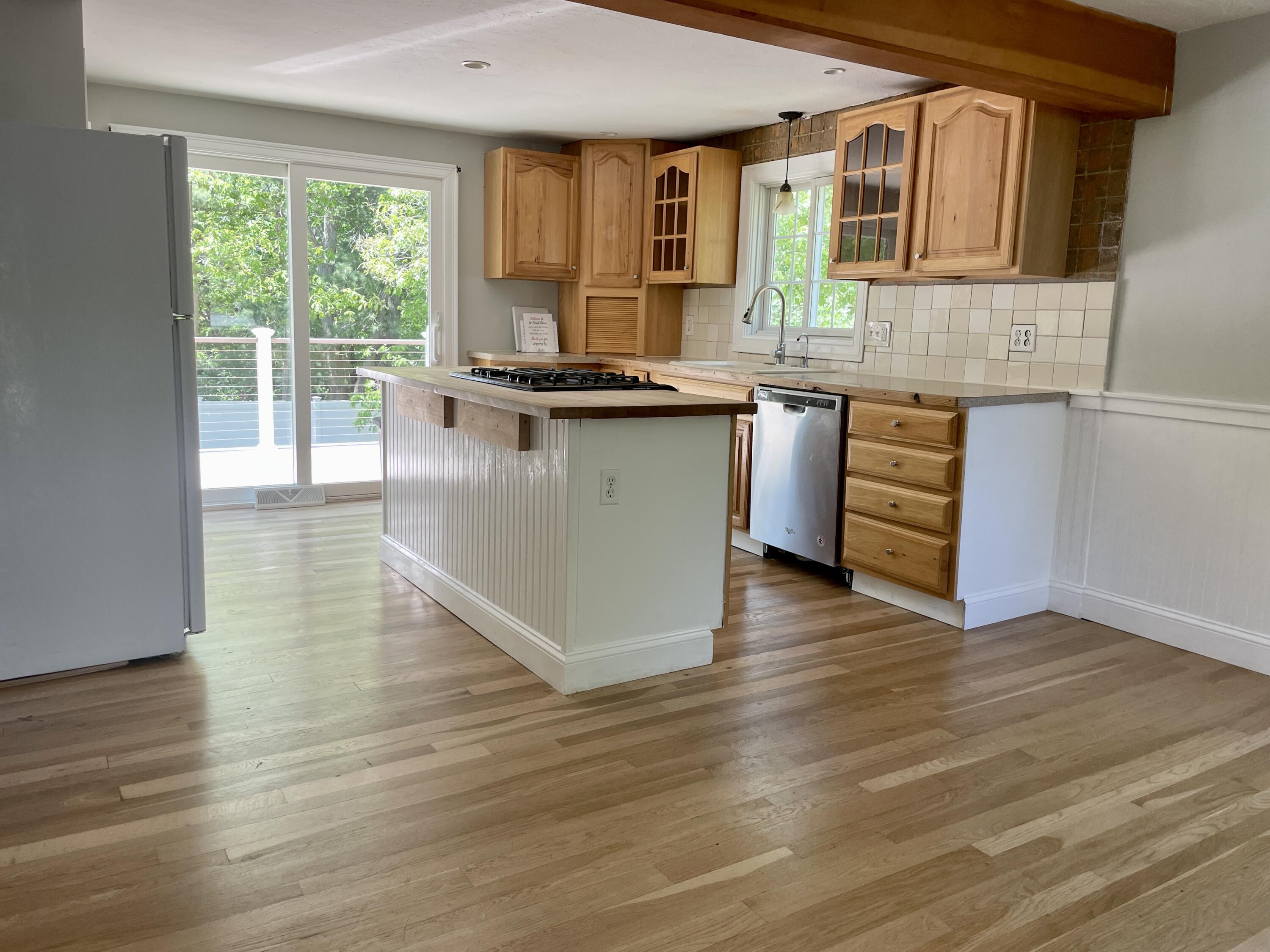 42 Forest Drive Mashpee, MA 02649 - Photo 7 of 55 a kitchen with granite countertop wooden floors and wide window