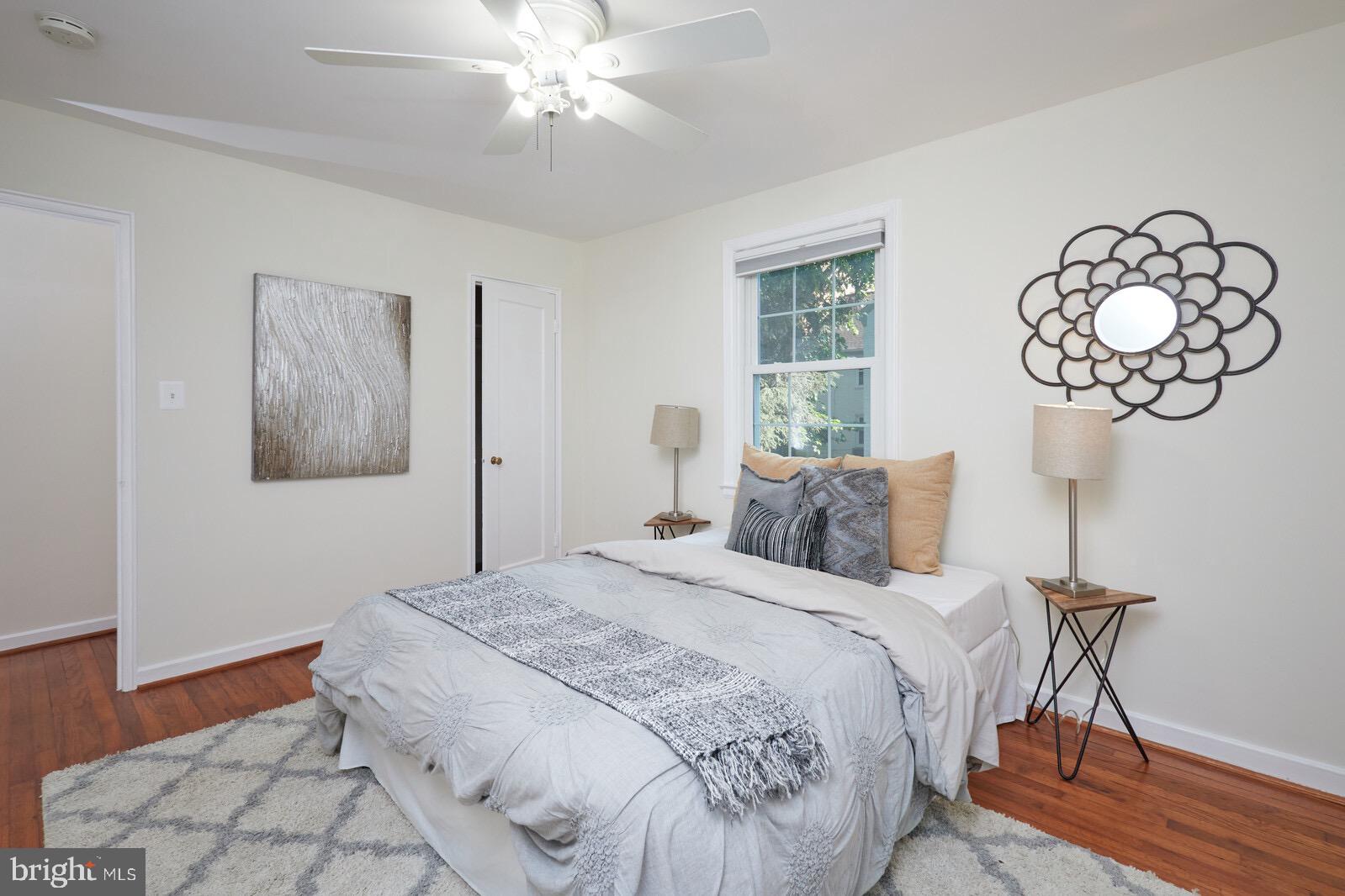 2215 Washington Avenue, Unit 103 Silver Spring, MD 20910 - Photo 11 of 26 a bed room with a bed and a chandelier