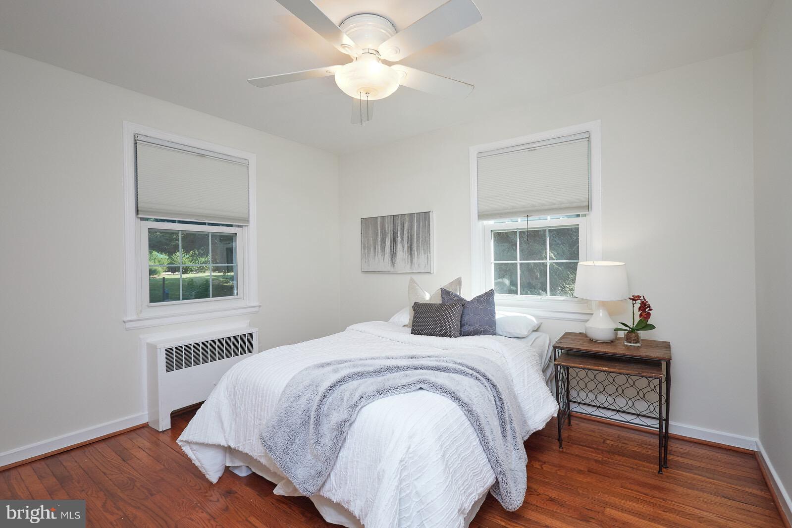 2215 Washington Avenue, Unit 103 Silver Spring, MD 20910 - Photo 12 of 26 a bedroom with a bed and wooden floor