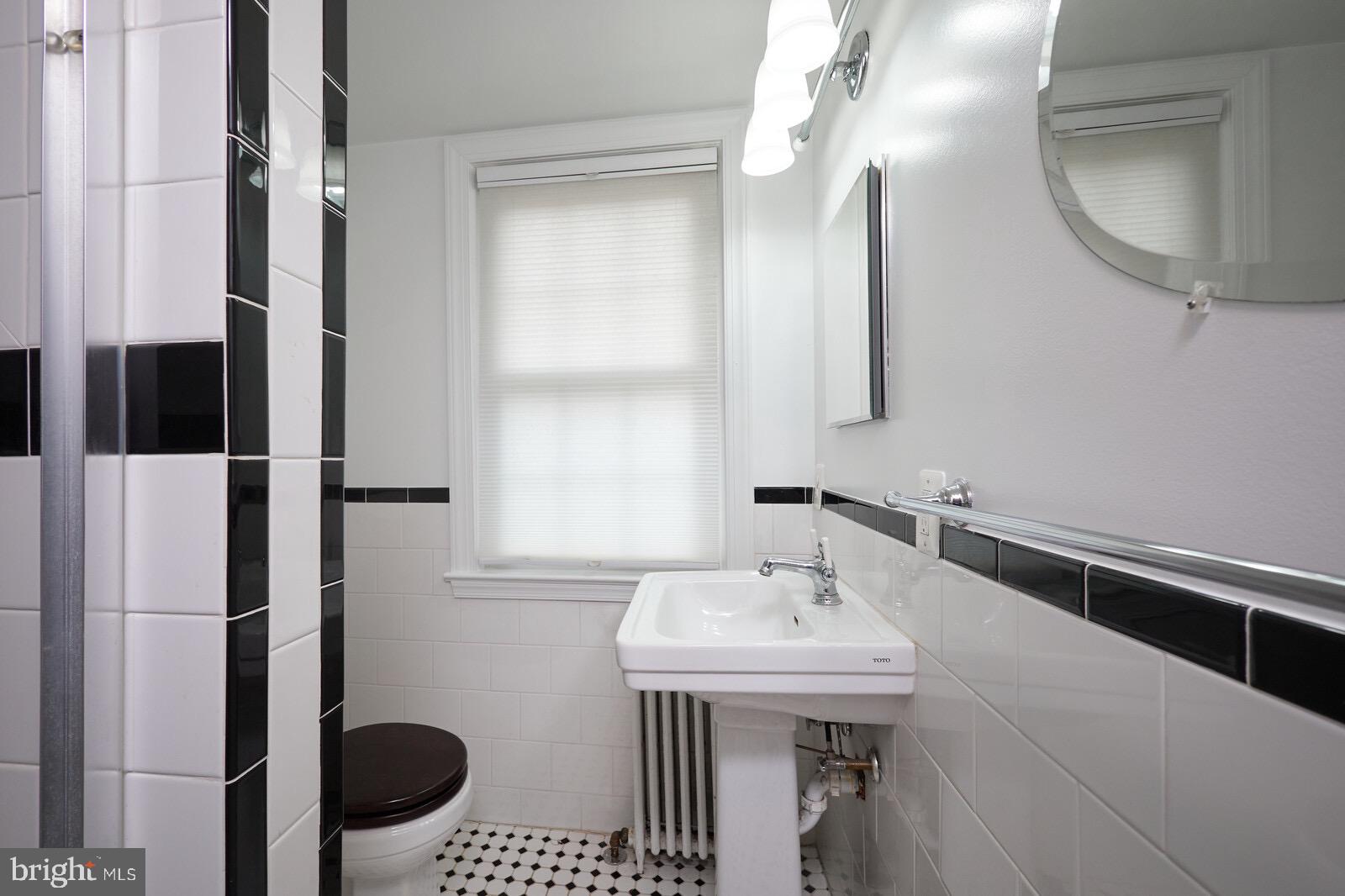 2215 Washington Avenue, Unit 103 Silver Spring, MD 20910 - Photo 13 of 26 a bathroom with a sink and a mirror