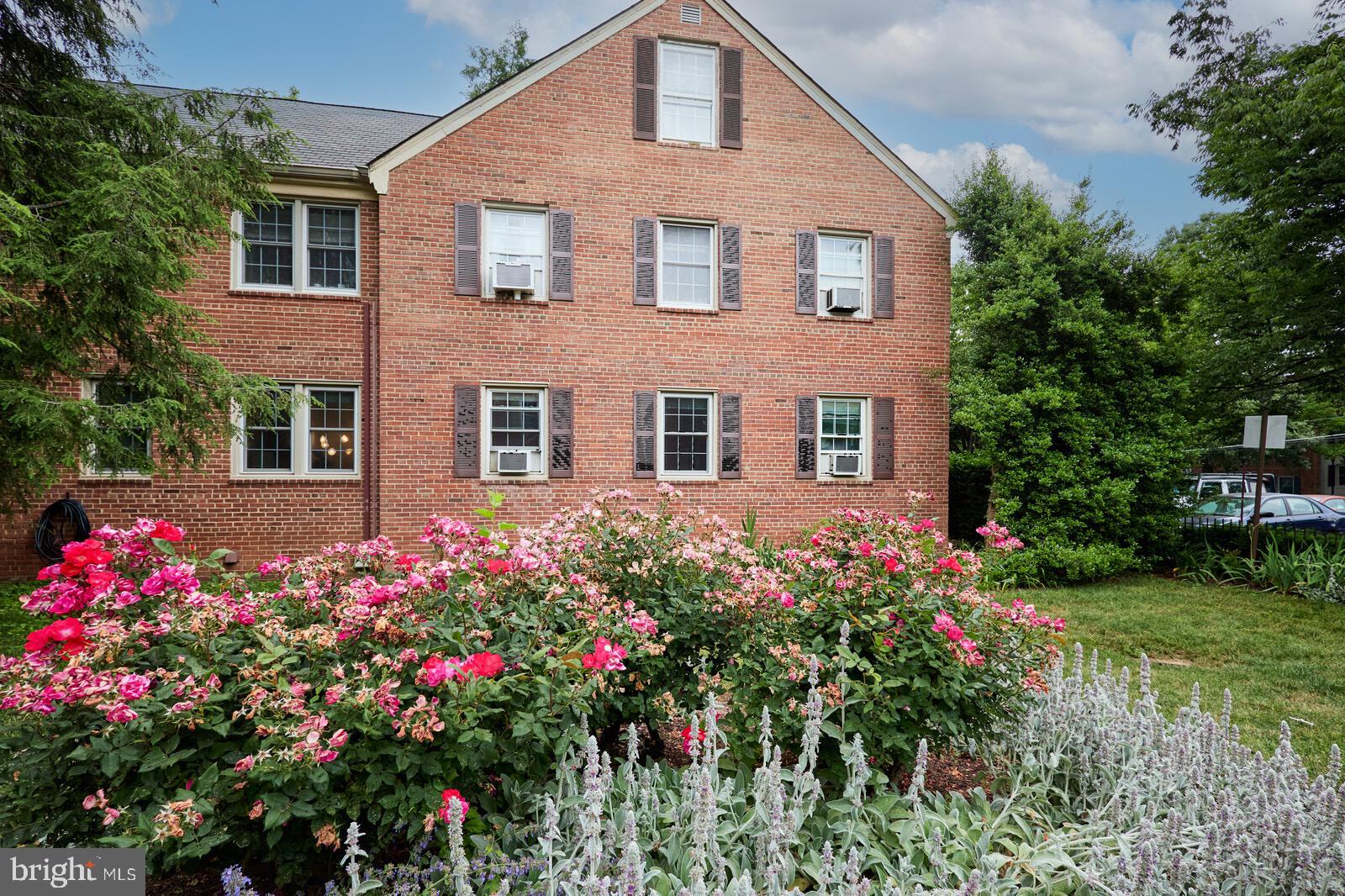 2215 Washington Avenue, Unit 103 Silver Spring, MD 20910 - Photo 19 of 26 a front view of a house with a yard and fountain