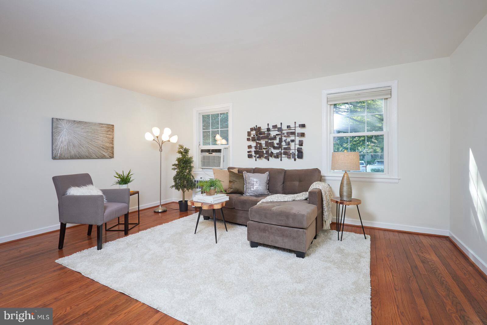 2215 Washington Avenue, Unit 103 Silver Spring, MD 20910 - Photo 2 of 26 a living room with furniture and a wooden floor
