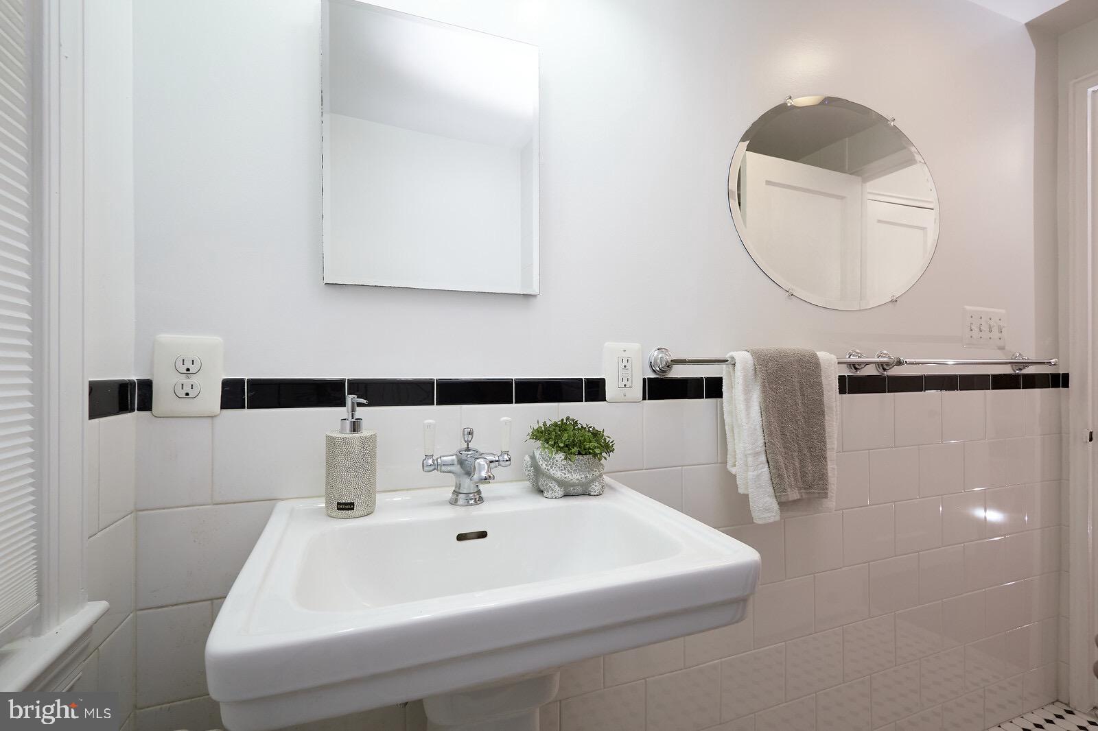 2215 Washington Avenue, Unit 103 Silver Spring, MD 20910 - Photo 26 of 26 a bathroom with a sink and a mirror