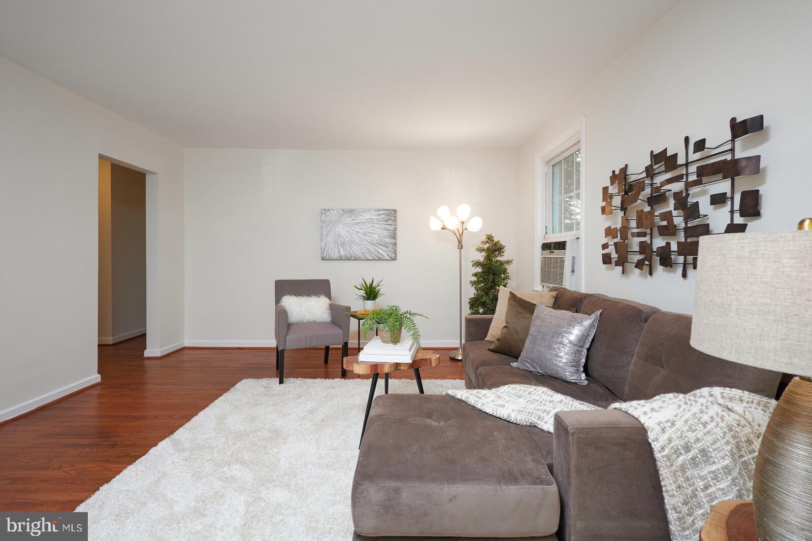 2215 Washington Avenue, Unit 103 Silver Spring, MD 20910 - Photo 4 of 26 a bed room with a bed and a chair