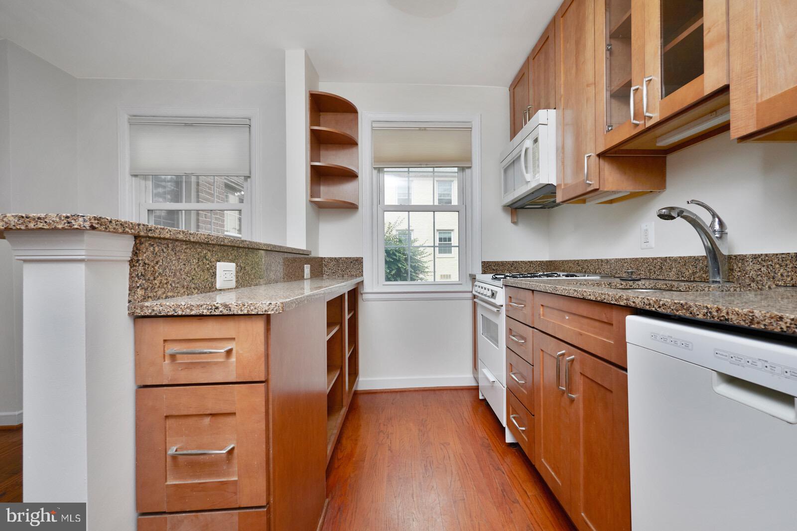 2215 Washington Avenue, Unit 103 Silver Spring, MD 20910 - Photo 7 of 26 a kitchen with stainless steel appliances granite countertop a stove and a sink