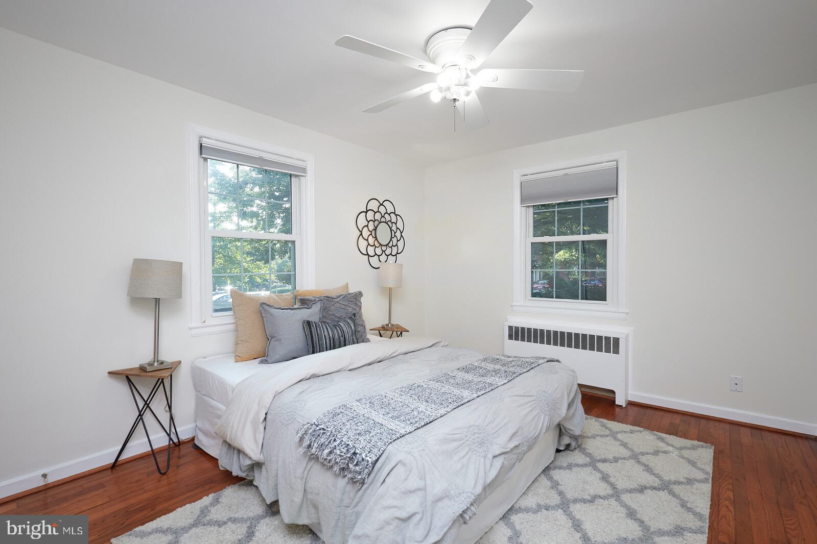 2215 Washington Avenue, Unit 103 Silver Spring, MD 20910 - Photo 10 of 26 a bedroom with a bed and a chandelier