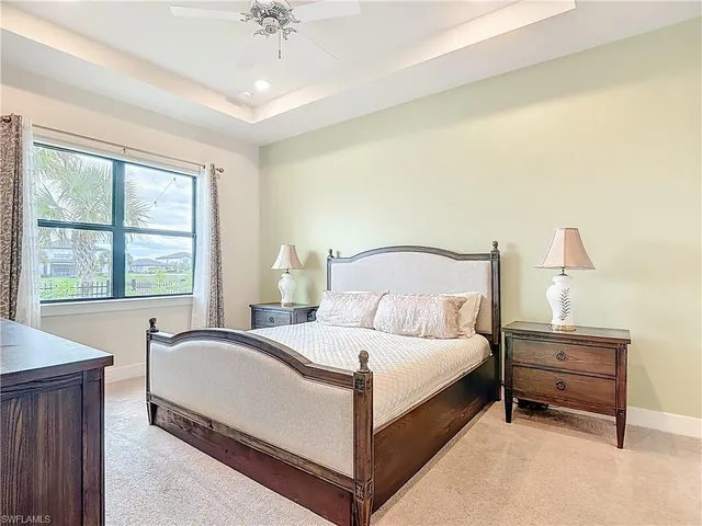 a large bedroom with a bed and a large window