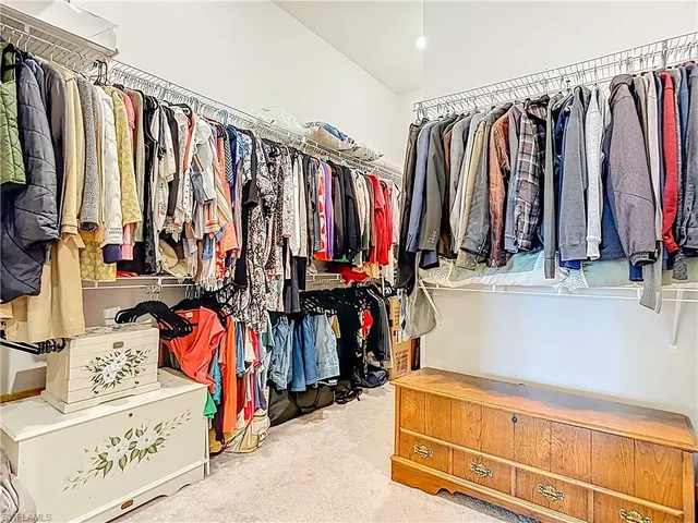 a view of walk in closet with clothes