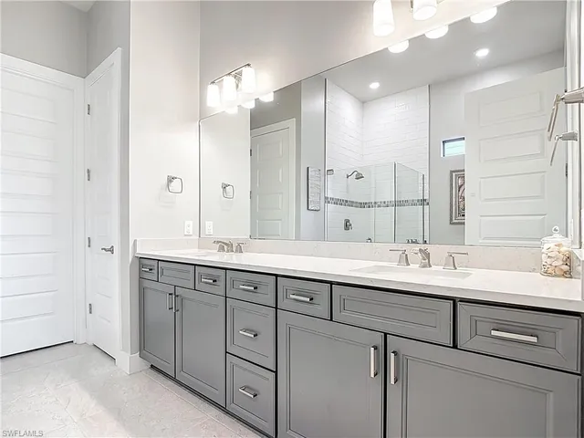 a bathroom with a double vanity sink and a mirror