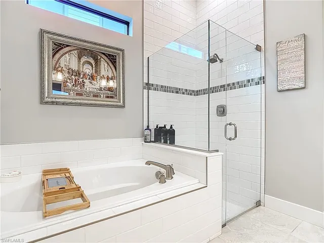 a bathroom with a bathtub and a shower