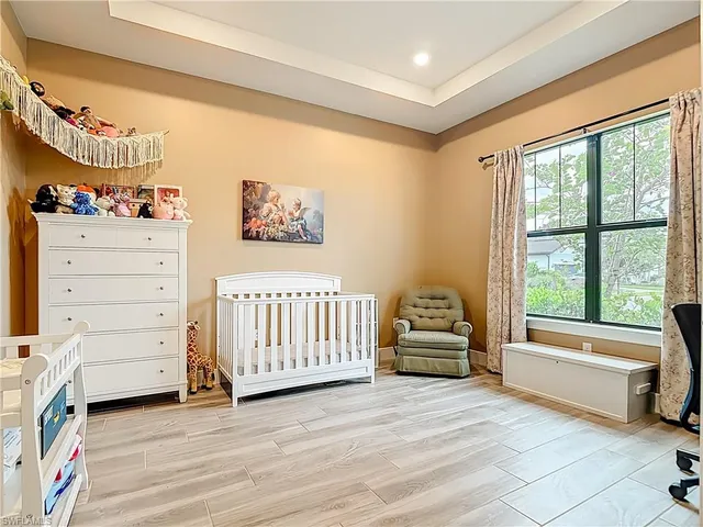 a spacious bedroom with a bed and a window