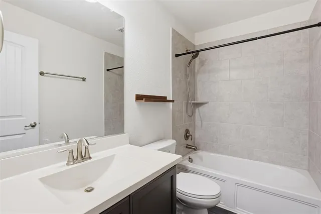 a bathroom with a sink a toilet and a bathtub