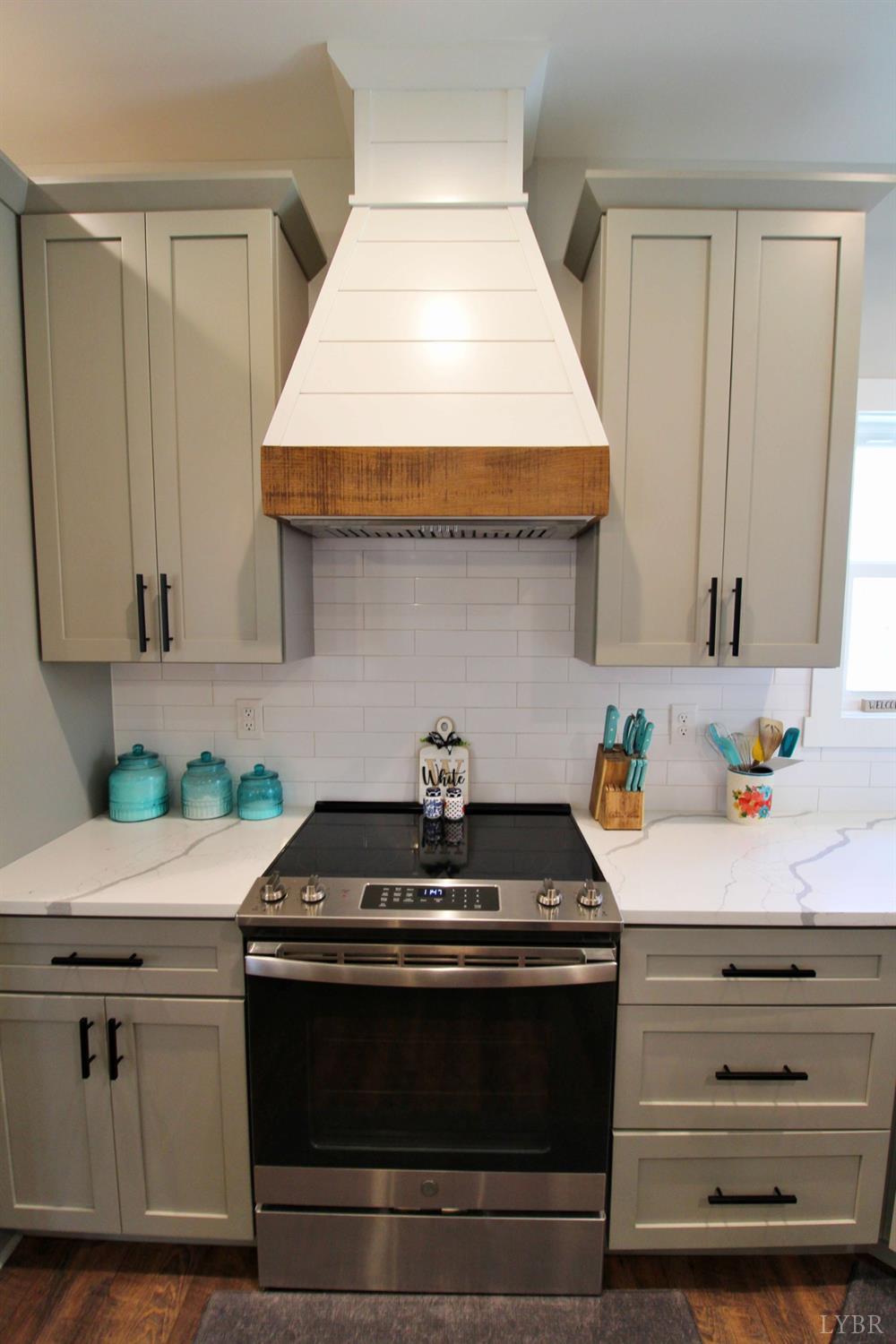 45 Langdon Road Evington, VA 24550 - Photo 23 of 74 a kitchen with granite countertop white cabinets and white appliances