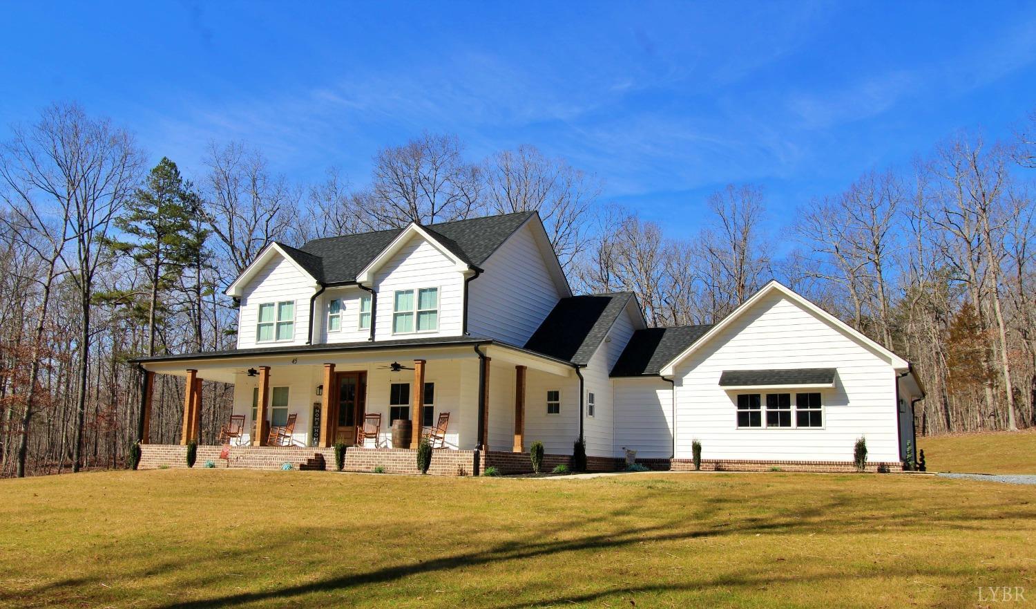 45 Langdon Road Evington, VA 24550 - Photo 3 of 74 a view of a big house with a big yard and large trees