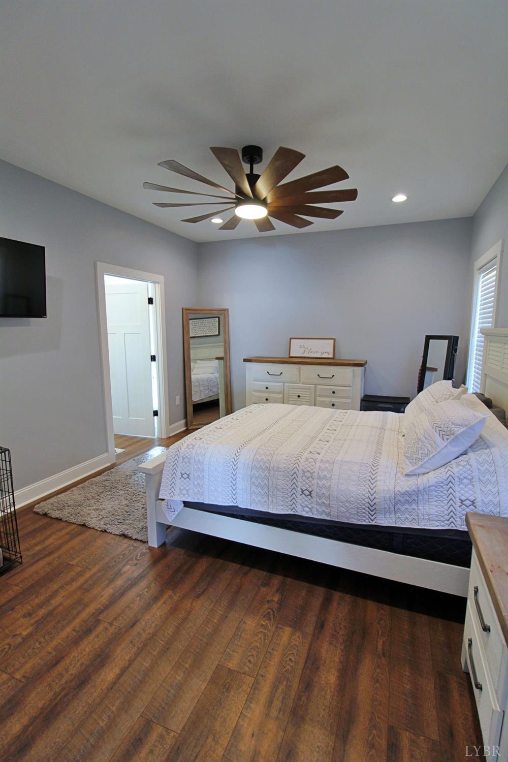 45 Langdon Road Evington, VA 24550 - Photo 37 of 74 a bedroom with large bed and a chandelier
