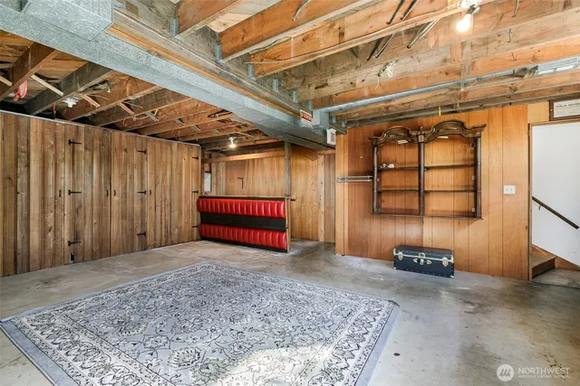 a view of a room with wooden walls and a rug