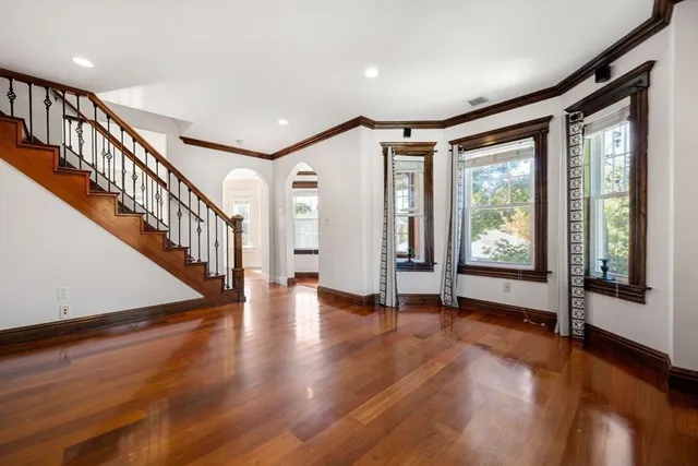 a view of an entryway with wooden floor door and windows