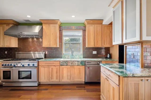 a kitchen with stainless steel appliances granite countertop a stove a sink and a granite counter tops