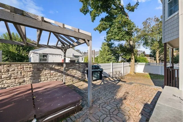 a view of a patio with table and chairs with wooden floor and fence