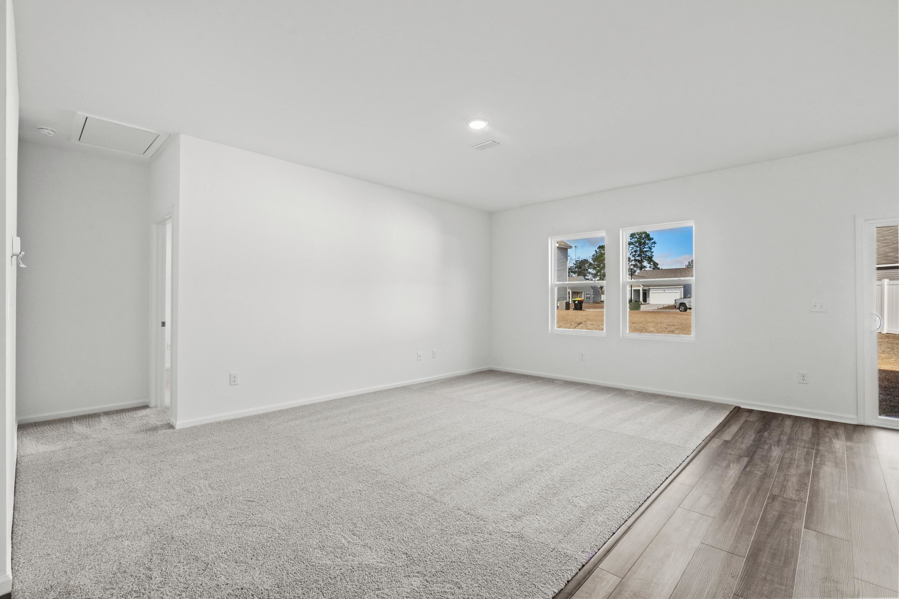 349 Sporting Drive Aynor, SC 29511 - Photo 6 of 31 Unfurnished room with wood finished floors and attic access