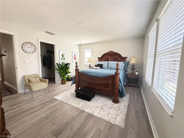 a living room with furniture a flat screen tv and kitchen view