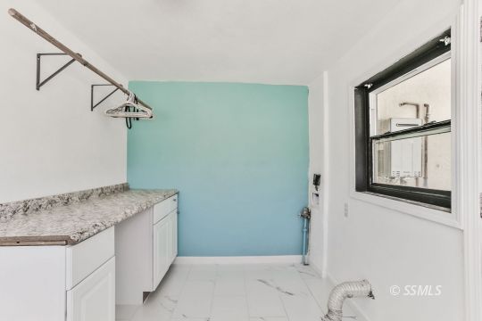 1415 Mayo Street Ridgecrest, CA 93555 - Photo 29 of 34 a bathroom with a granite countertop sink and a mirror