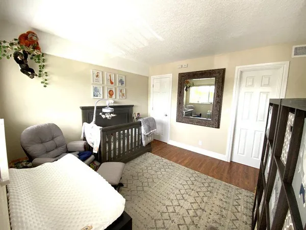 a bedroom with furniture and wooden floor