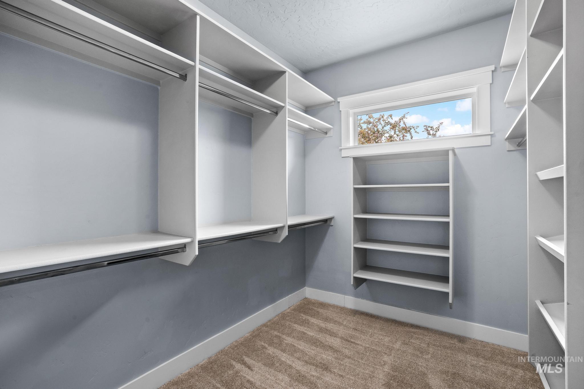 2681 East Rhyolite Court Nampa, ID 83686 - Photo 29 of 48 Walk-in closet with built-in shelving, hanging rods, and a window for natural light
