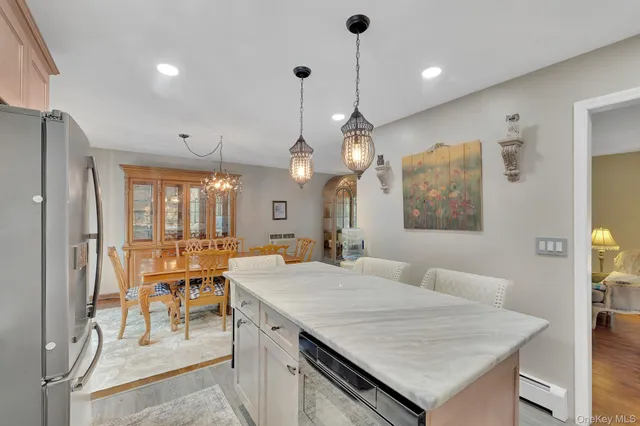 a large kitchen with kitchen island a table and chairs