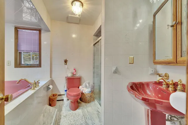 a bathroom with a sink mirror and toilet