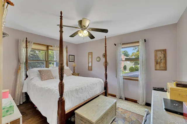 a bedroom with a bed chandelier and a window