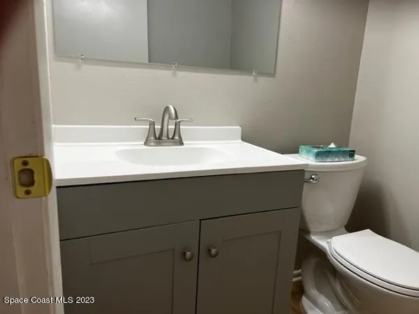 a bathroom with a sink a toilet and mirror