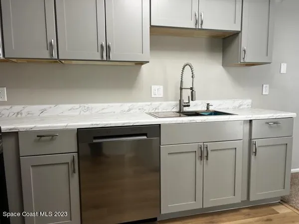 a sink with white cabinets
