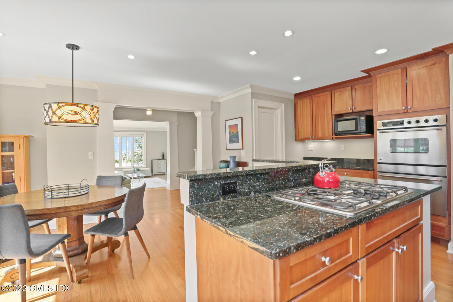 7 Owenoke Way Riverside, CT 06878 - Photo 11 of 37 a kitchen with stainless steel appliances granite countertop a stove top oven a sink a dining table and chairs with wooden floor