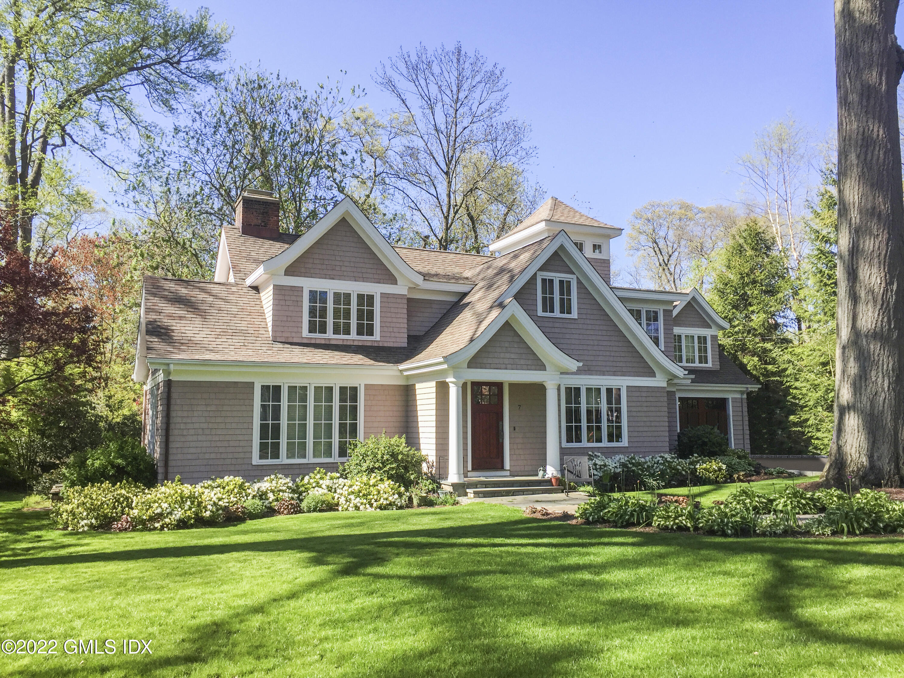 7 Owenoke Way Riverside, CT 06878 - Photo 2 of 37 a front view of a house with a yard and garage